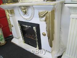 Cream and gold fireplace with medusa logo and plaque and electric fire