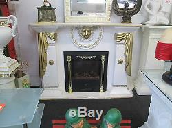 Cream and gold fireplace with medusa logo and plaque and electric fire